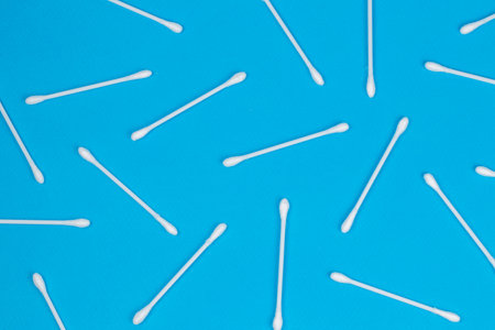 Cotton swabs on blue background. Top view ear sticksの写真素材