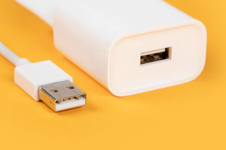 Usb cable with usb connector on yellow background.