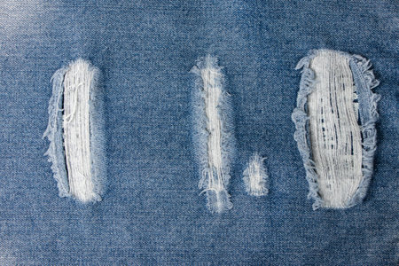 White stitching on blue denim jeans patch. Close up blue jean frameの写真素材