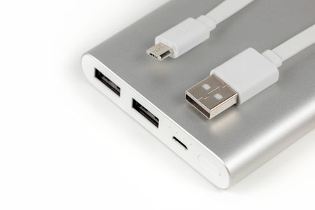 Power bank for charging mobile devices. White smart phone charger with power bank (battery bank)....