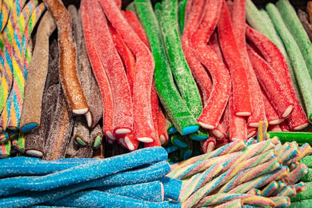 Candies with jelly and sugar. colorful array of different childs sweets and treats. Bright party background.の写真素材