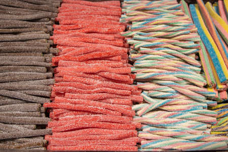 Candies with jelly and sugar. colorful array of different childs sweets and treats. Bright party background.の写真素材