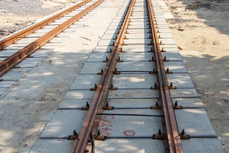 Repair of two-way tram tracks, laying of iron rails on reinforced concrete sleepers, the prospect of a repair site to the horizon.の写真素材