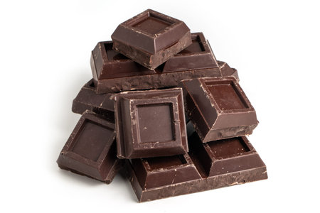 Broken pieces of dark chocolate close up.