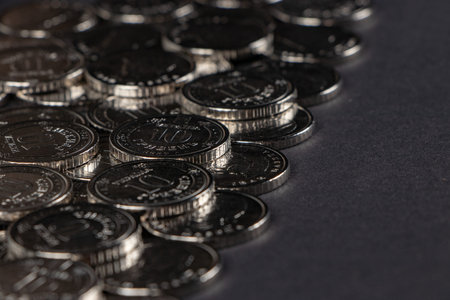 Silver coins on dark background. Ukrainian 10 hryvnias coins. Money and finances. Ukrainian coins