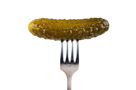 Marinated cornichon on the fork isolated on the white background.の写真素材