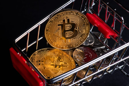 Metallic shiny bitcoin cryptocurrency coin with Ukrainian hryvnia coins in grocery shopping cart. Electronic decentralized money concept. legalize bitcoin and cryptocurrencies in Ukraine.の写真素材