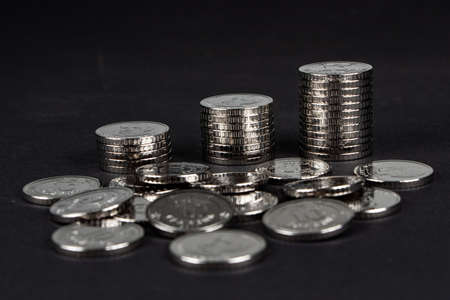 Ukrainian 10 hryvnias coins. Money and finances. Stack of 10 hryvnia coins, on a dark background. Ukrainian coins.の写真素材