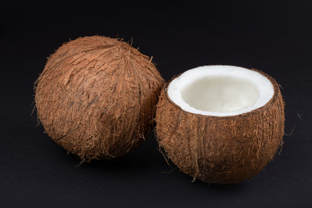 Coconuts on a dark background. half coconut