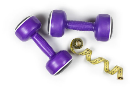 Dumbbells and measuring tape on white background.の写真素材