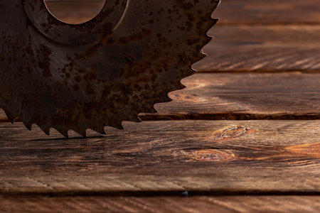 Old circular saw blade on wooden background.の写真素材