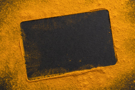 Frame made of yellow powder on a black background. concept.の写真素材