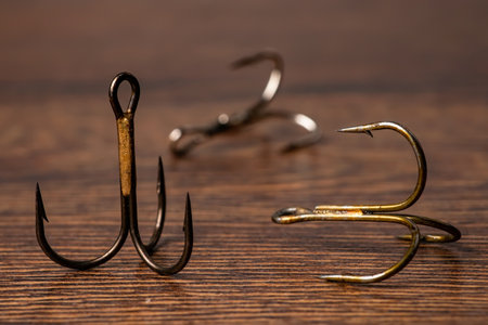 Fish Hooks with 3 hooks on a wooden background.の写真素材
