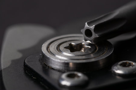 Close up macro on screwdriver unscrewing torx screw.の写真素材