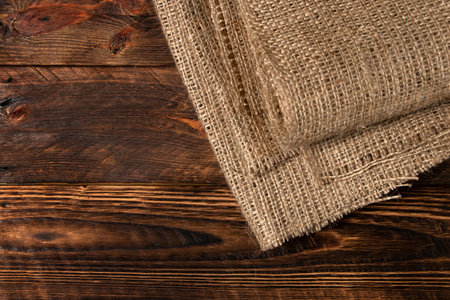 Wood table with old burlap tablecloth texture.の写真素材
