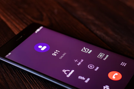 Emergency call, dialing 911, call 911, call help service 911. Emergency concept: digital phone with emergency call on the screen. All screen graphics are made upの写真素材
