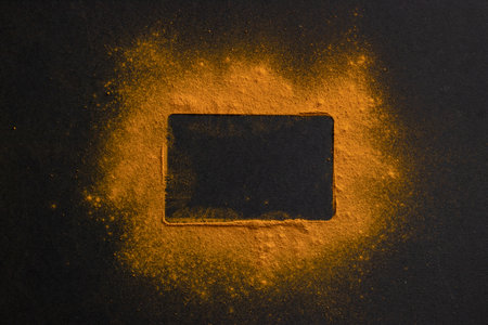 Frame made of yellow powder on a black background. concept.の写真素材