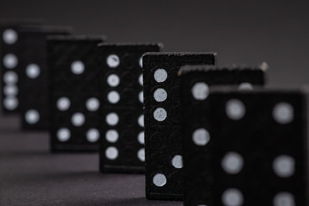 Black Dominoes on dark background, Closeup scattered dominoes on a gray, table. Board game, Game night Dominos table game.の写真素材