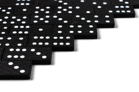 Black dominoes on a white background, top view. board game. Place for text.の写真素材