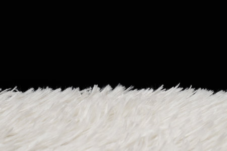 Synthetic fur white texture on black background.の写真素材