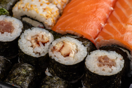 Japanese sushi food. Maki ands rolls with tuna, salmon, shrimp, crab and avocado. Top view of assorted sushi, all you can eat menu. Rainbow sushi roll, uramaki, hosomaki and nigiri.の写真素材