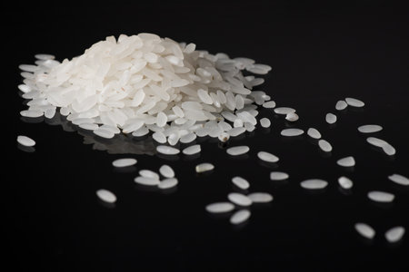 Pile white rice on black background. close up.の写真素材