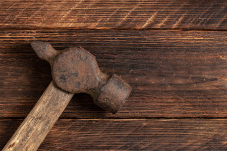 Old and rusty iron hummer on wooden background.の写真素材