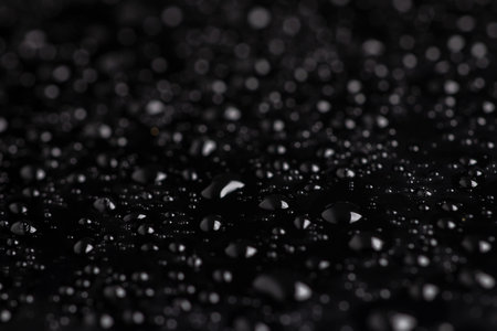 Water drops on the surface covered with foil. surface tensionの写真素材