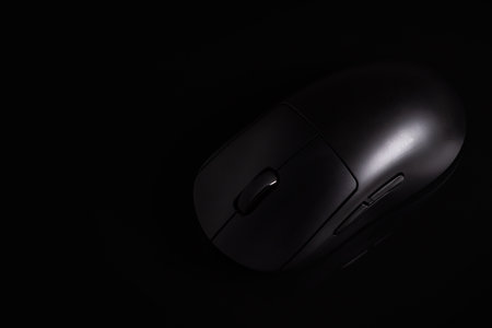 Black modern wireless computer mouse on black background.の写真素材