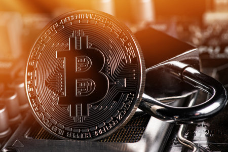 bitcoin with locker on motherboard. Cryptocurrency law. digital security. BTC banned.の写真素材
