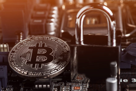 bitcoin with locker on motherboard. Cryptocurrency law. digital security. BTC banned.の写真素材