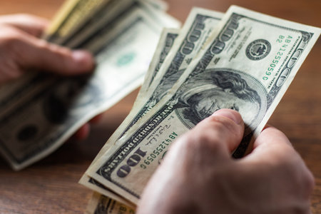 Close up male hand Counting money us dollar. financial business concept