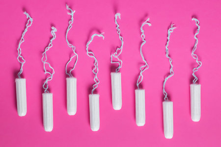 menstrual period concept. Woman hygiene protection. Cotton tampons on pink background