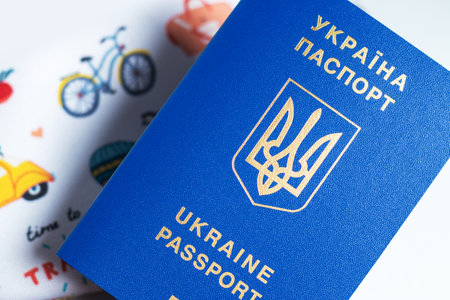 New ukrainian blue biometric passport with identification chip on travel background.の写真素材