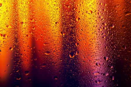 Water drops and condensation in a window glass. Abstract background niglt light.の写真素材