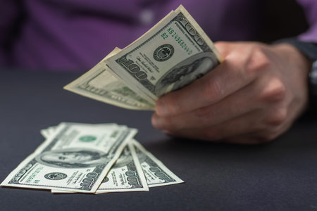 Close up male hand Counting money us dollar. financial business concept