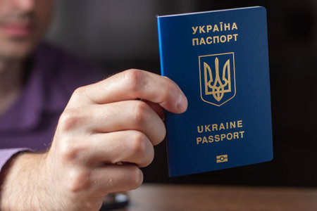 New ukrainian blue biometric passport with identification chip in hands.の写真素材