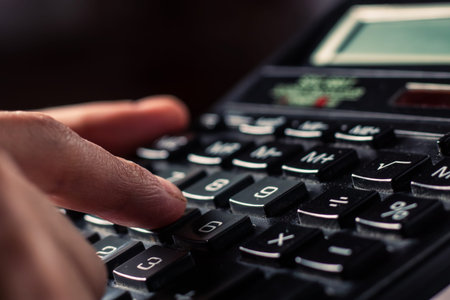Close up businessman hand using calculator calculate about finance accounting at coffeeshop outdor....