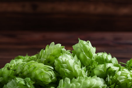 Pile fresh green hops on a wooden table. close up.