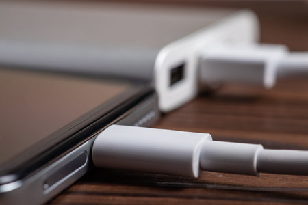 Smartphone charging with white power bank. close-up at white power bank