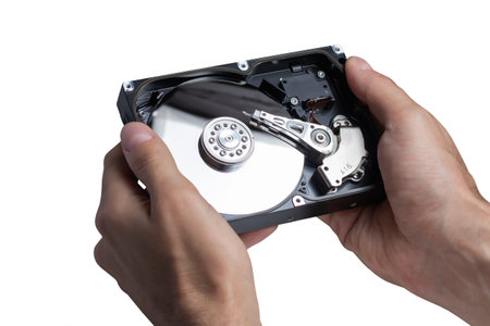 Open hdd in hands on white background close up.