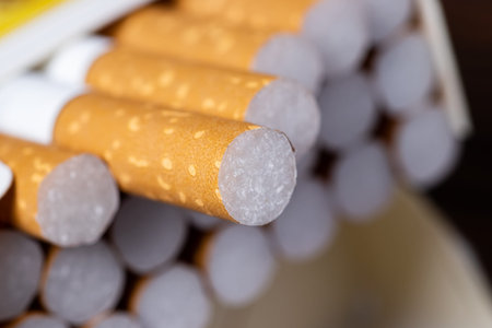 Cigarettes in a pack. yellow filter. Harm to health. bad habit. A pack of cigarettes on the table....