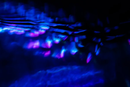 Blurred Light painting one exposure in camera. light glares with a spectral gradient on a dark background. Multicolored abstract colorful line. Unusual light effect.の写真素材