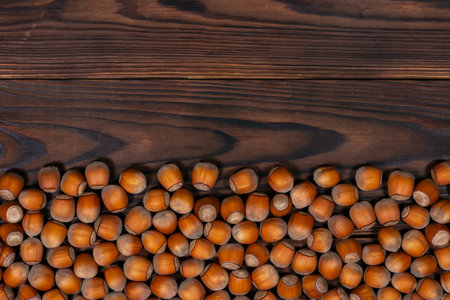 Close up brown hazel nut on wooden desk. Healthy organic vegetarian snack hazelnut. background.の写真素材