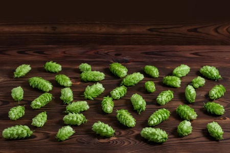 Hops cones on wooden background. background pattern hopの写真素材