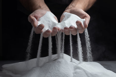 Men's hands keep sand in their palms and spilling grains of sand through their fingers. Concept of the flow of lifeの写真素材