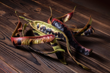 Acacia seeds on wooden background. close up.