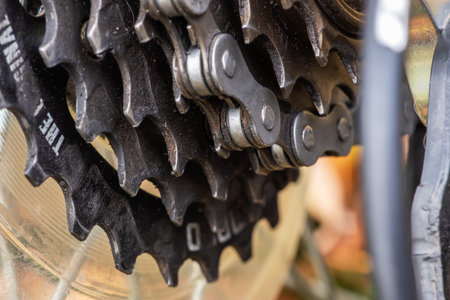 Dirty bicycle drive train. Gravel Bike Transmission in Mud. Dirty Chain Drive of Mountain Bike After...