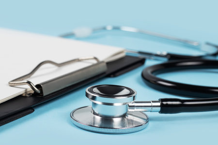 blank clipboard with modern stethoscope, space for messages.の写真素材