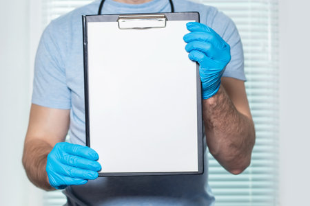 Doctor showing blank clipboard to write it on your personal message or advice.の写真素材